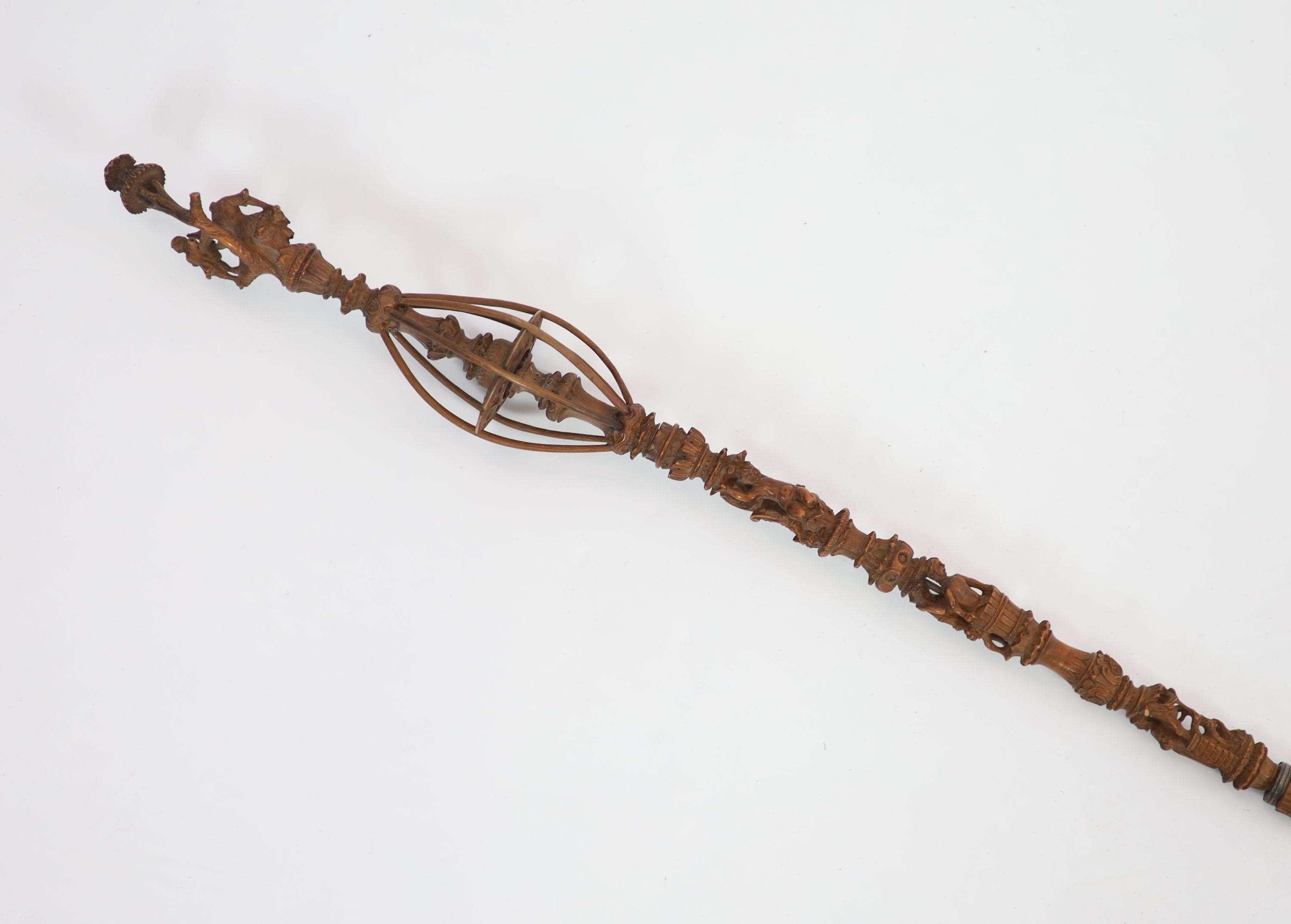 A 17th century French boxwood distaff (wool winder), carved with numerous figures and scrolls, over a spiral fluted stem, 49 & 36cm.